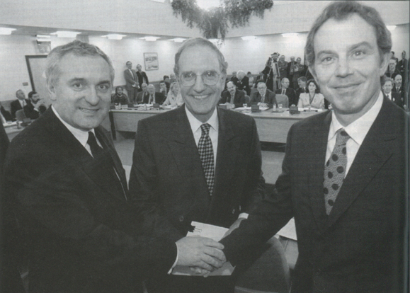 Irish Taoiseach Bertie Ahern, talks chairman George Mitchell and British Prime Minister Tony Blair shake hands after the peace deal was struck on Good Friday in Belfast.