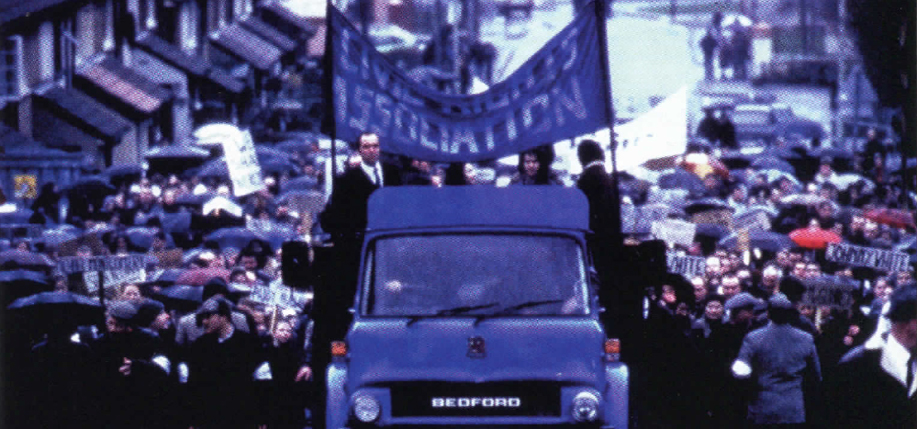 James Nesbitt (on truck) as politician Ivan Cooper leads marchers before violence erupts in Bloody Sunday.