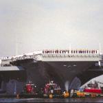 Two of the most modern Moran tugs guide the U.S.S. Roosevelt from Norfolk harbor following September 11, 2001.