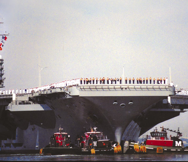 Two of the most modern Moran tugs guide the U.S.S. Roosevelt from Norfolk harbor following September 11, 2001.