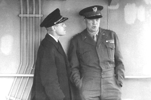 <em>Captain Edmond J. Moran chats with General Eisenhower. Later promoted to Rear Admiral, Moran organized the towing of artificial harbors to the beaches at Normandy, making D-Day landings possible. For his service he was awarded the Legion of Merit, the Croix de Guerre, and the Order of the British Empire.</em>