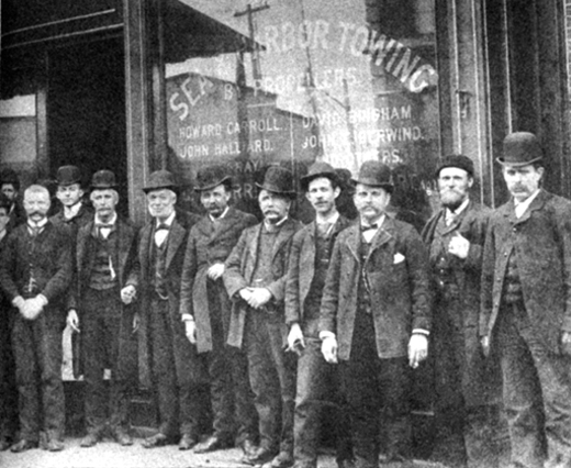 <em>Michael Moran (holding cigar, fourth from the left), with his associates on South Street, then known as the Street of Ships.</em>