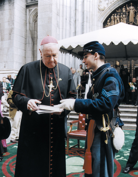 <em>During the St. Patrick's Day Parade, Robert Carter presents Cardinal Egan with <strong>Memoirs of Chaplain Life</strong> by Father William Corby, a chaplain of the original Irish Brigade.</em>