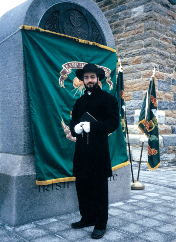 <em>Robert Carter reenacts the roll of chaplain at the 1997 dedication of the monument to the Irish Brigade at Antietam. The uniform, down to the hat, which he had custom made, is based on his research of original photographs.</em>