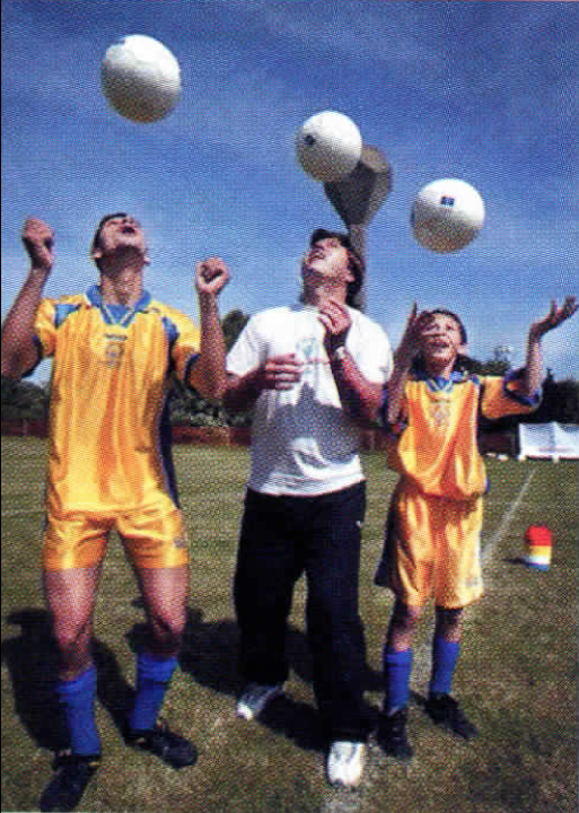 <em>Special Olympic athletes from Cyprus, Emilios Loannou (left) and Petrov Kleovoulos (right), receive soccer tips from coach Roman Koseckiv.</em>