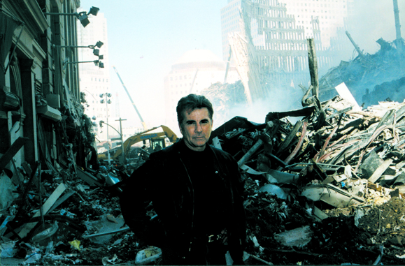 <em>Walsh at Ground Zero beginning the hunt for the September 11, 2001 terrorists on <strong>America's Most Wanted</strong>.</em>