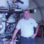 Terry Kerby standing in front of the Pisces IV.