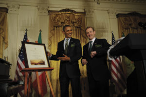 Taoiseach Enda Kenny presents President Obama with his certificate of Irish heritage.