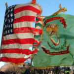 The U.S. flag and the flag of the Irish brigade fly together. Photo courtesy of the 69th NYSV Historical Association