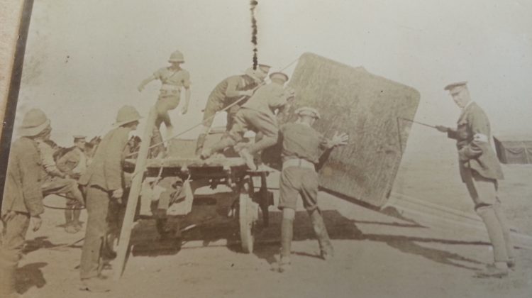 Soldiers unload supplies in Galippoli as Major William Egan, far right supervises.