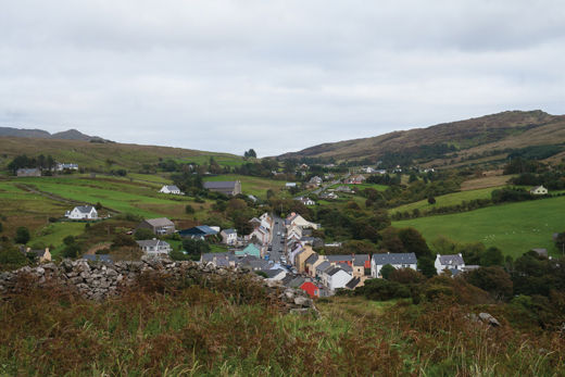 <em>View from the monastic site at the old church down to the village, looking east. The main road is seen as it leaves Kilcar in direction to Killybegs.</em>