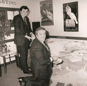 Adrian, pictured in his studio with Congressman Brian Donnelly, counting Donnelly visa applications.