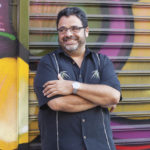 Arturo O'Farrill pictured in front of some Brooklyn street art.