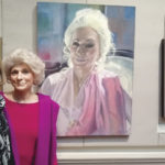 The artist Louise Peabody and singer Judy Collins pose in front of Peabody’s portrait of Collins at the Century Club.