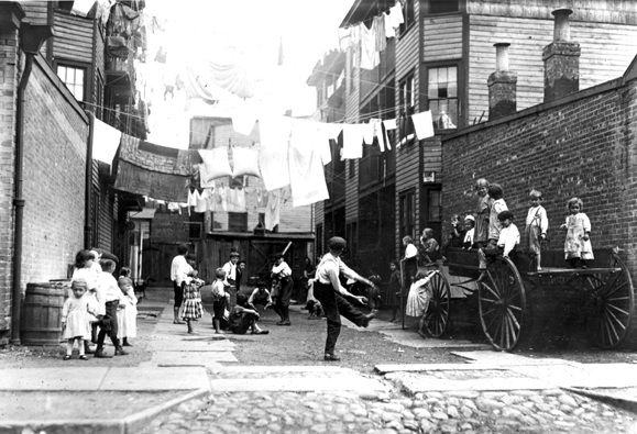 <em>Backyard playground used by Irish immigrant children, Boston, 1912.</em>