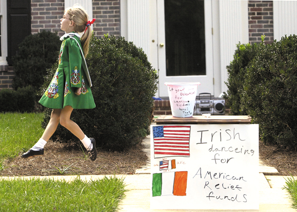 Collier Wimmer, aged 9, performs in front of her home in Winston-Salem, North Carolina to raise funds for the victims of the September 11 tragedy.