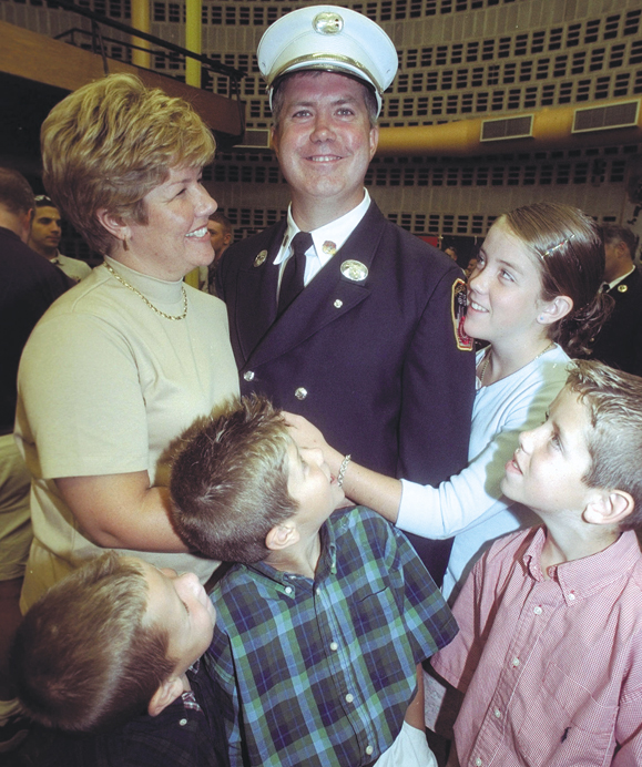 <em>Firefighter Timothy Stackpole, promoted to Captain with his family at a ceremony at Randall's Island FD, Left to right,front row: Terence,6; Brendan,9; Brian,10. Rear row; his wife Tara; daughter Kaitlyn, 15.</em>
