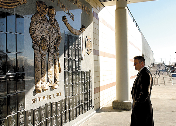 John Kelly, trustee of Uniformed Firefighters Association, at the Brooklyn Wall of Remembrance. The wall is engraved with images of the 115 Brooklyn firefighters who lost their lives on 9/11.