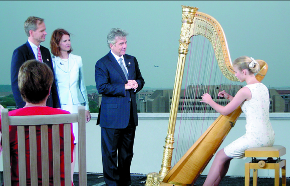 <em>Left to right Ed Smart, Lois Smart, John Walsh, and Elizabeth Smart playing the harp during a taping of <strong>The John Walsh Show</strong>.</em>