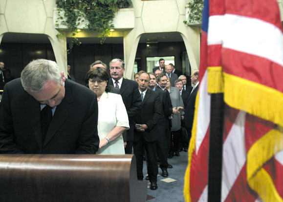 Taoisearch Bernie Ahern and Tanaiste Mary Harney with members of the Irish Cabinet sign the book of condolences in the US Embassy in Dublin three days after the terrorist attacks.