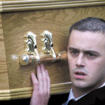 John Lawlor, brother of murdered Catholic teenager Gerard Lawlor, carries his coffin from his North Belfast home. Lawlor was shot dead by an Ulster Freedom Fighter (UFF) gunman.