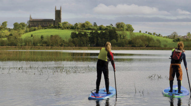 Pam Martin and Eddie Hawkins of Wild Rover Adventures paddle the River Quoile towards Down Cathedral, where St. Patrick is buried.