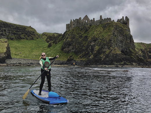 Pam paddles by Dunluce Castle during a trip along the cliffs of the Causeway Coast.