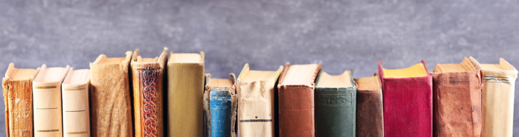 Library books adorn the top of the Irish America Archives page.