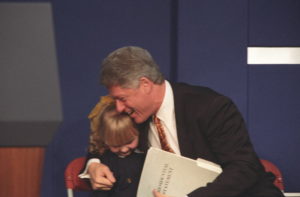 President Clinton hugs a young girl named Catherine Hamill on the dais at the Mackie Plant in Belfast in 1995.  Photo: Sharon Farmer, Clinton Digital Library 