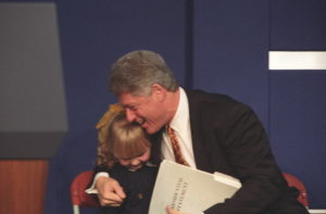 President Clinton hugs a young girl named Catherine Hamill on the dais at the Mackie Plant in Belfast in 1995. Photo: Sharon Farmer, Clinton Digital Library