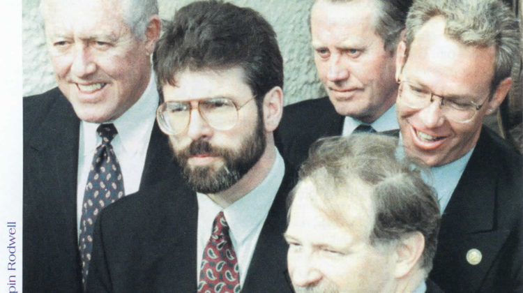 Standing in the shadows: At Sinn Féin headquarters (left to right) Chairman of Mutual of America Bill Flynn, Sinn Féin leader Gerry Adams, Chuck Feeney, Congressman Bruce Morrison, and Irish American Labor Coalition leader Bill Leenihan. Belfast, December 17, 1997.