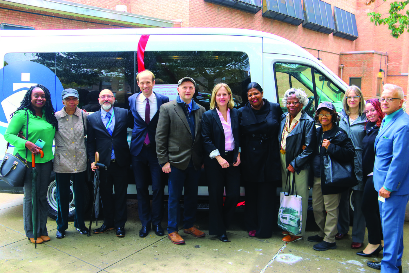 Then Queensboro president, Melinda Katz, who supported funding to purchase vehicles for TFH’s Good Health Shuttle fleet, gathers with Floating Hospital staff and members of her team in front of a new minibus at a dedication ceremony in October 2018.