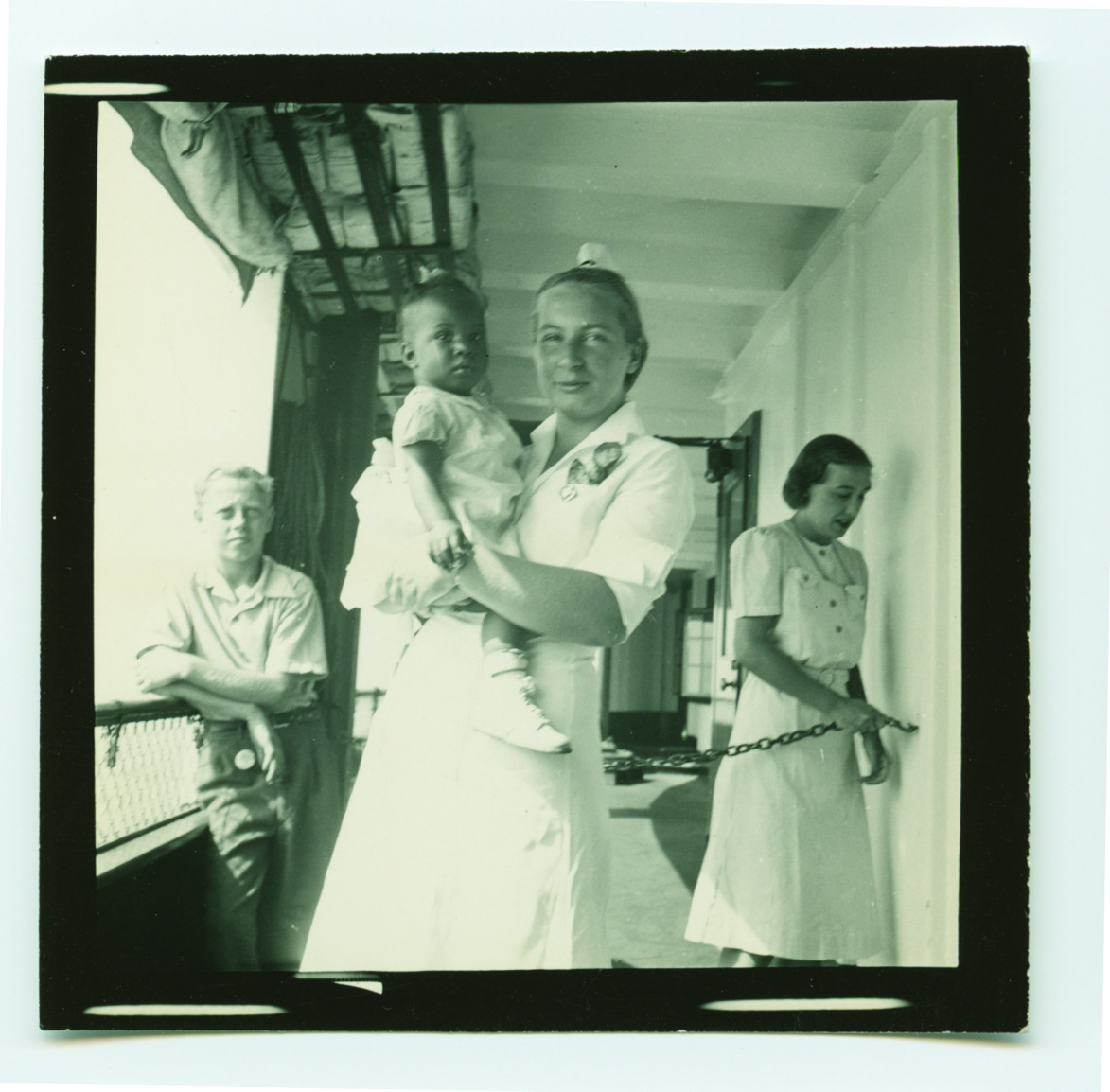 A nurse holding a tiny patient aboard the ship in 1941.