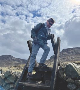 John Kernaghan steps down a stile during a 10-mile hike through the Mourne Mountains, a rugged destination south of Belfast.