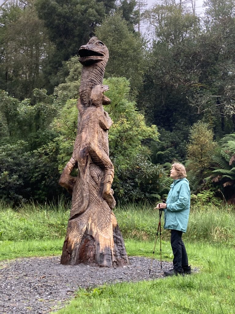 Rita with one of the dinosaur carved logs