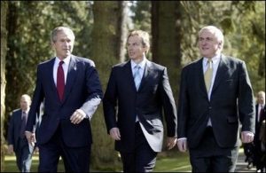 President George W. Bush walks with British Prime Minister Tony Blair, center, and Irish Prime Minister Bertie Ahern at Hillsborough Castle. Photo georgewbush-whitehouse.archives.gov