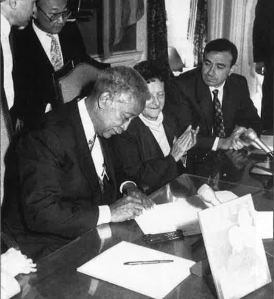 Former NYC mayor David Dinkins signs a document creating the street sign for Joe Doherty on Manhattan's Pearl Street.