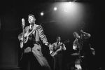 Elvis Presley performing with Scotty Moore and Bill Black in 1956.