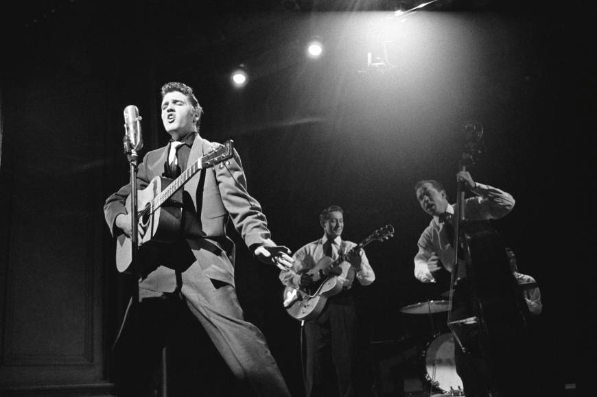 Elvis Presley performing with Scotty Moore and Bill Black in 1956.